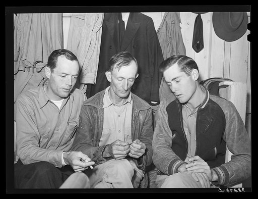 Three men workers at naval air base from Louisiana. These men are living in a tourist court and had to leave their families in Louisiana because they could not find suitable housing facilities. Corpus Christi, Texas