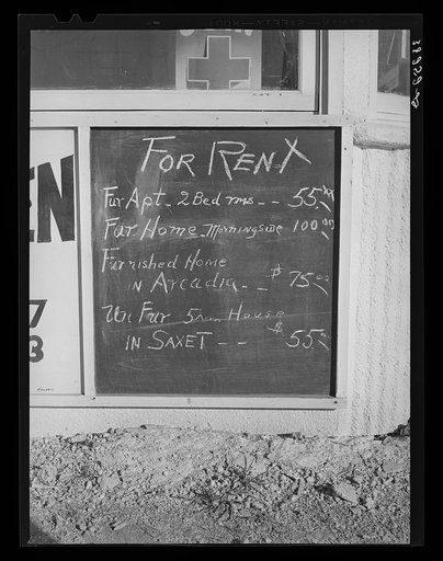 Untitled photo, possibly related to: Sign in front of real estate office which shows the rent scale. Corpus Christi, Texas
