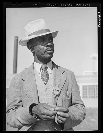 Workman at the naval air base. Corpus Christi, Texas. Notice his identification badge which allows him to enter base. Picture taken on Sunday