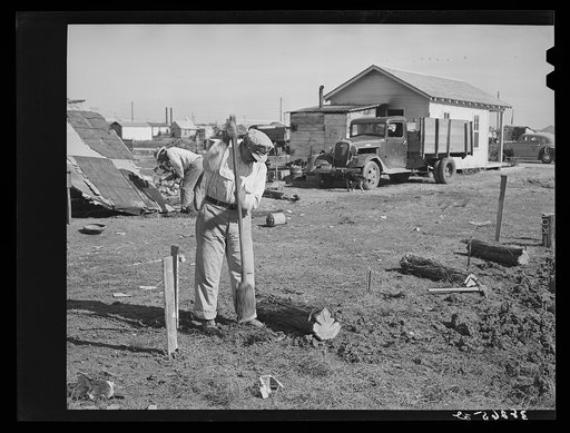 Man working on foundation for new house in cheap residential section of Corpus Christi, Texas. Many cheap houses are now being built to satisfy the demand of workmen and their families for housing