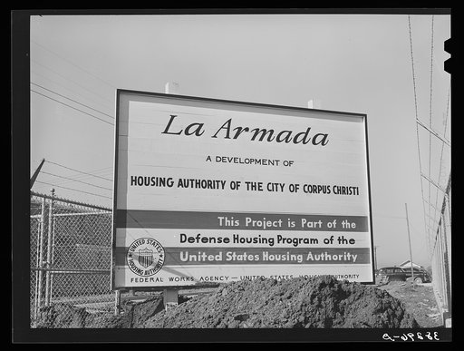 Sign at U.S.H.A. project under construction. Corpus Christi, Texas. This project will provide housing for two hundred forty-nine married enlisted men and civilian employees at the naval air training base. Corpus Christi, Texas