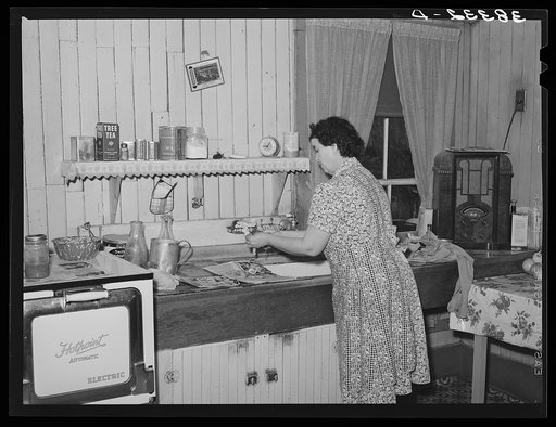 Wife of farmer in her kitchen. Auburn, California. Notice the electric stove, running water and radio. Electrification has been general in this section for twenty years