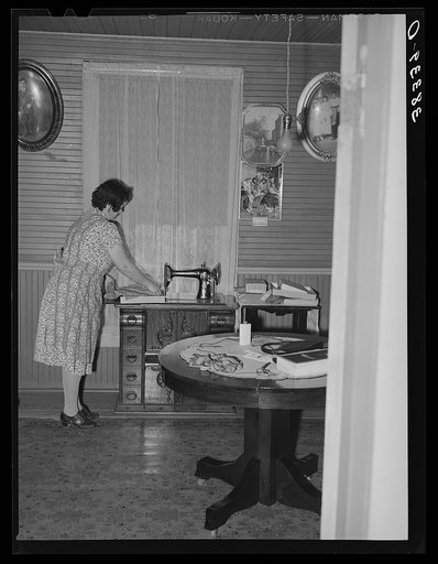 Farmer's wife at her sewing machine, near Auburn, Placer County, California