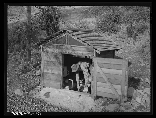 Untitled photo, possibly related to: Fruit farmer in springhouse. Placer County, California. Notice the electric pump which makes possible running water in the house