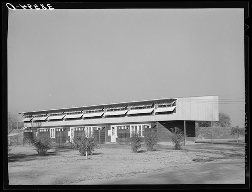 Untitled photo, possibly related to: Row of apartments for permanent farm workers at the Yuba City farm workers' camp. Yuba City, California