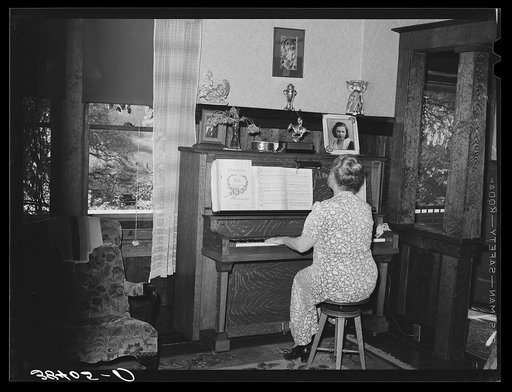 Fruit farmer's wife playing piano. Placer County, California. Because they have not changed the variety of plums and pears which they raise to meet changed market conditions they have gone further and further into debt to the Federal Land Bank and are now on verge of losing their four hundred acre f