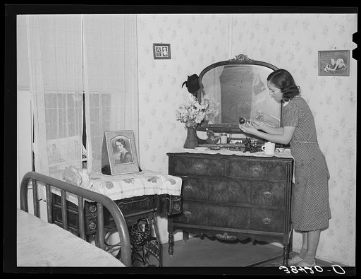 Fruit farmer's wife in bedroom of her house. Placer County, California