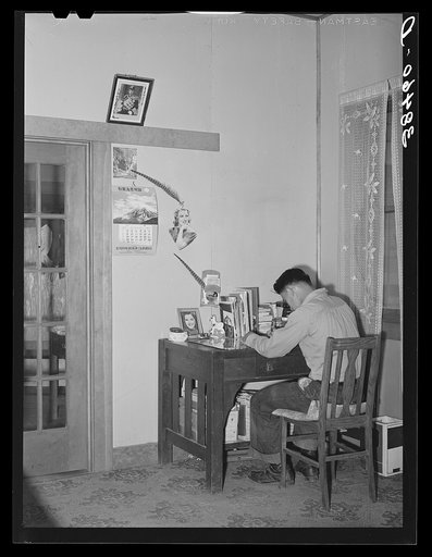 Son of Japanese fruit farmer at his desk. Placer County, California