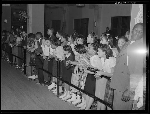 Crowds watching rollerskating exhibition. Chicago, Illinois