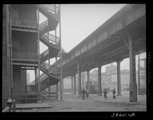 Children playing under the elevated on the southside of Chicago, Illinois