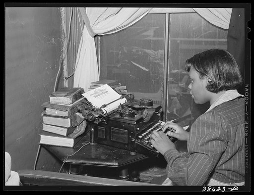 Wife of a railroad worker typing a letter. Chicago, Illinois