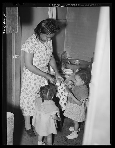 Wife of railroad worker feeding her children. Chicago, Illinois