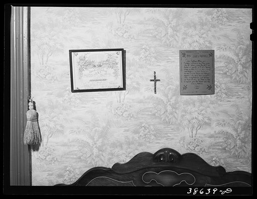 Marriage license and Lord's Prayer above bed in Negro home. Chicago, Illinois