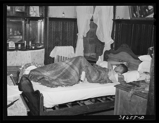 Bedroom in apartment house rented to Negroes. Chicago, Illinois