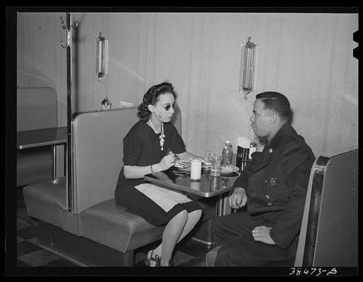 Policeman talking to employee of Ten-cent store whose trade is predominantly Negro. Chicago, Illinois