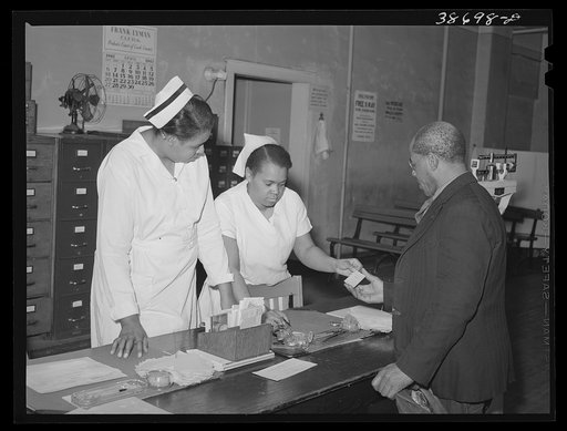 Clinic patient receiving instruction card at municipal tuberculosis sanitarium. Chicago, Illinois