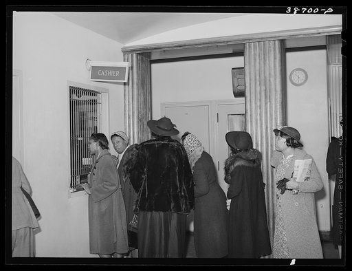 Patients at clinic paying bills. Chicago, Illinois