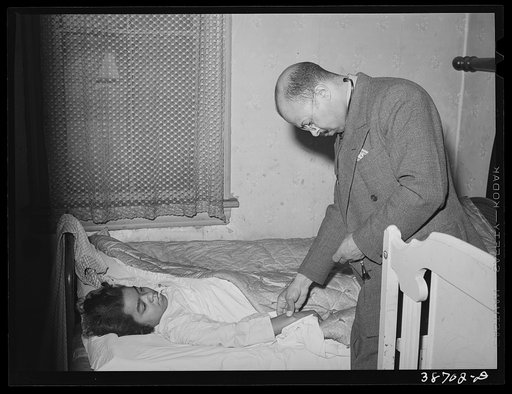 Doctor examining patient in her home. Family is on relief. Chicago, Illinois