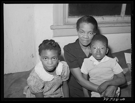 Mother with her children at home. Chicago, Illinois