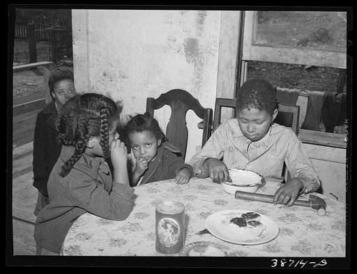 Negro children eating biscuits. Chicago, Illinois