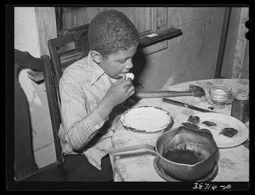 Negro boy eating. Chicago, Illinois