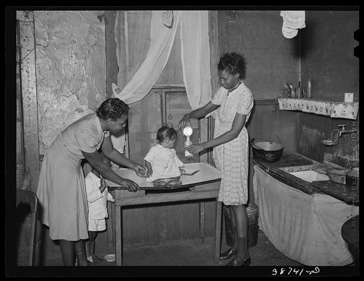 Preparing milk for baby. Family is on relief. Chicago, Illinois