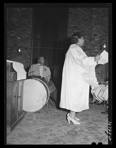 One of the leaders of the Pentecostal church leading singing. Chicago, Illinois