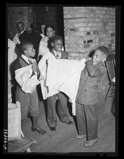 Boys of children's choir putting on their robes. Chicago, Illinois