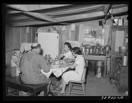 The Browning family eating lunch. They are FSA (Farm Security Administration) rehabilitation borrowers on the Vale-Owyhee irrigation project. Dead Ox Flat, Malheur County, Oregon