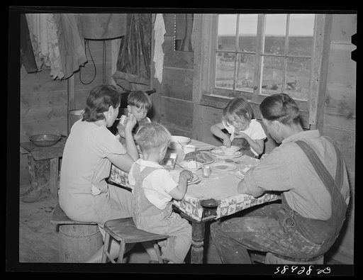 The Ray Halstead family eating dinner. They are FSA (Farm Security Administration) rehabilitation borrowers on Dead Ox Flat. Malheur County, Oregon. He rents his land