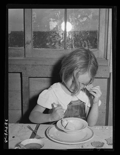 Daughter of Ray Halstead eating ice cream made in her mother's electric refrigerator. He is an (Farm Security Administration) rehabilitation borrower. Dead Ox Flat, Malheur County, Oregon. The report "New farms on new lands"  by Carl P. Heisig and Marion Calwson, Bureau of Agricultural Economics, wi