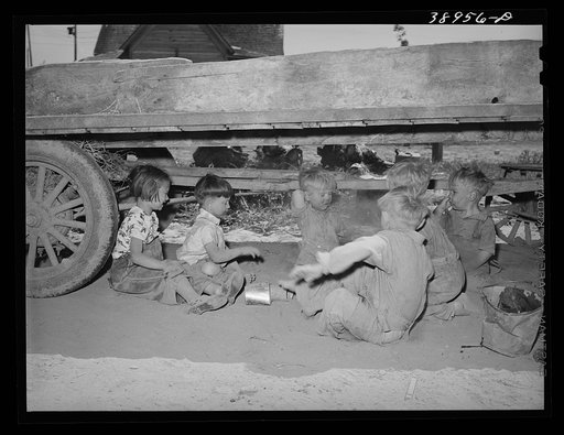 Untitled photo, possibly related to: Children playing under wagon at the Schroder farm, FSA (Farm Security Administration) rehabilitation borrowers living on Dead Ox Flat. Vale-Owyhee irrigation project, Malheur County, Oregon