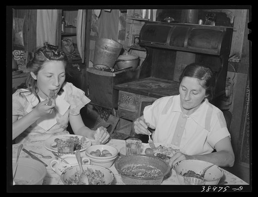 Mrs. Browning and her daughter eating dinner. This family does much canning in line with FSA (Farm Security Administration) live at home program. They are FSA rehabilitation borrowers at Dead Ox Flat, Malheur County, Oregon