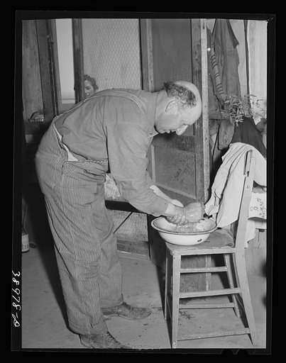 Mr. Browning washes for dinner. He is a (Farm Security Administration) rehabilitation borrower. Dead Ox Flat, Malheur County, Oregon