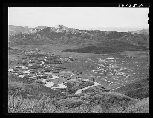 Yampa Valley, Routt County, Colorado, with snow-covered Rocky Mountains in the background. Notice the flooded fields caused by rapidly melting snows in the spring