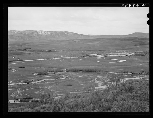 Yampo Valley, Routt County, Colorado, with snow-covered Rocky Mountains in the background. Notice the flooded fields caused by rapidly melting snows in the spring
