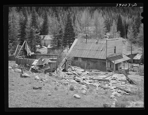 Bourne, Oregon. Crumbling buildings in a ghost mining town. The town came into existence in the 1870s and was notorious for the wildcat venture. Exodus from the camp occured in 1906 and most of the mines have remained closed. In the 1940 Oregon state guide (Federal Writers Project)  the population w
