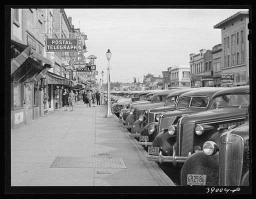 Main street of Twin Falls, Idaho. Among industries in this town are a sugar beet factory, cannery and it is a shipping center for potatoes and onions