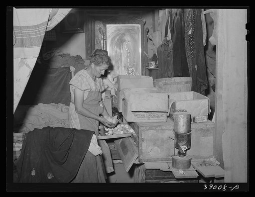 Mrs. Free, wife of FSA (Farm Security Administration) rehabilitation borrower, with incubator in her basement house. Dead Ox Flat, Oregon