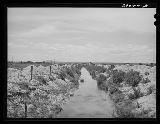Irrigation lateral ditch to provide water for farms on the Vale-Owyhee irrigation project. Notice that the piles of dirt on the sides give some indication of the relative newness of this project. Malheur County, Oregon