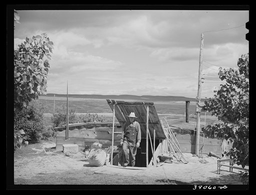 Basement house of Mrs. White, FSA (Farm Security Administration) rehabilitation borrower. Dead Ox Flat. Many of these basement houses are seen on the Owyhee Irrigation Project and after about five years on the land, the farmers are generally in a position to build their permanent houses, utilizing t