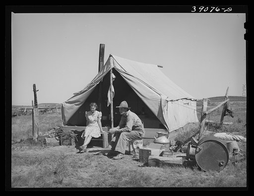 Farmer and his wife in front of their tent home. Vale-Owyhee rrigation project, Malheur County, Oregon. This is their first year on this land, in fact, they had been here only two months. This year they will devote time, energy and money to getting their land into cultivation. Livestock and chickens