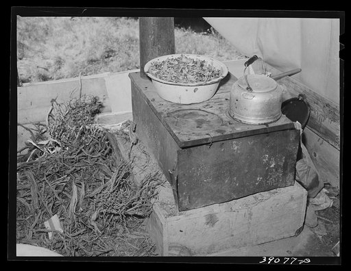 Cook stove in tent home of young farmer and his wife. Vale-Owyhee irrigation project, Malheur County, Oregon. This is first year on this land, in fact, they had been here only two months. This year they will devote time, energy, and money to getting their land into cultivation. Livestock and chicken