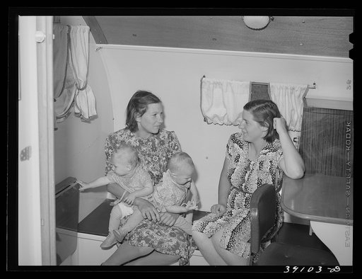 Wives and children of farm workers in the trailer-clinic at the FSA (Farm Security Administration) migratory labor camp mobile unit. Wilder, Idaho. Main activity of the clinic centers around first aid treatment and preventative serums. In this particular clinic, serum for prevention of wood tick fev