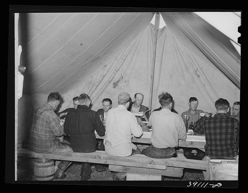 Sheep shearers eating dinner in central tent of the outfit. Ranch in Malheur County, Oregon