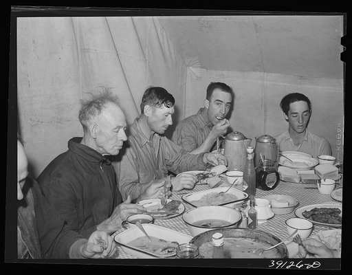 Untitled photo, possibly related to: Sheep shearers eating dinner in central tent. Ranch in Malheur County, Oregon. The wife of the owner and boss of the outfit does the kraut and ham, dried beans, canned tomatoes, potatoes, pudding, jams and jellies, coffee and tea
