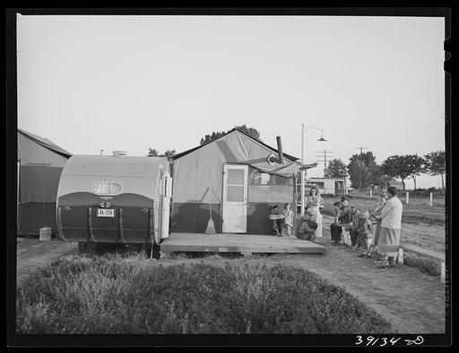 Farm workers and their children waiting for clinic time at the trailer. FSA (Farm Security Administration) migratory labor camp mobile unit. Wilder, Idaho. Most of these people were getting serum for prevention of wood tick fever