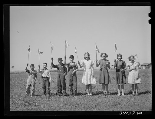 Flag drill for entertainment at end of school term at the FSA (Farm Security Administration) camp for farm workers. Caldwell, Idaho
