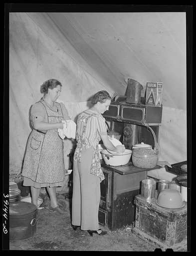 Washing dishes after dinner at the sheep shearers' camp. Ranch in Malheur County, Oregon