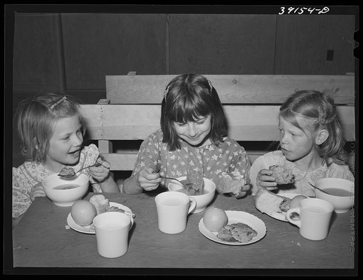 Schoolchildren eating lunch at the FSA (Farm Security Administration) farm workers' camp. Caldwell, Idaho